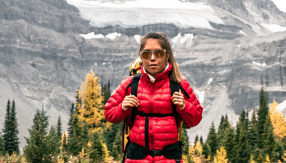 Woman wearing the Dasche L3 Jacket while hiking in a mountain range.