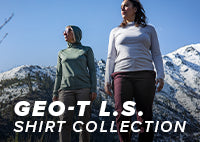 Two women hikers wearing the Geo-T L.S. on a hike in a mountain range.